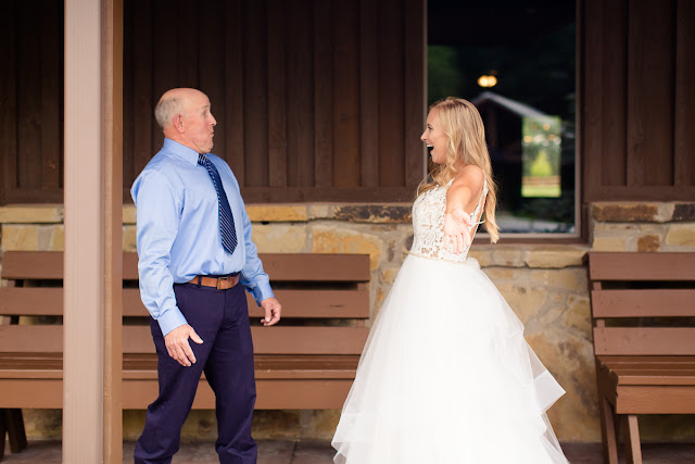 Something old, something new, something borrowed, something blue.  Sarah looked like she could have stepped right out of a Vogue Bridal magazine as she floated down the stairs in her beautiful wedding gown: a fitted, sleeveless, delicate lace bodice above a floor-length skirt, comprised of yards and yards of whimsical, white organza.  Tanner looked dapper in his royal blue suit, paisley tie, white rose boutonniere, and fancy, wood-grained leather shoes.  The bridesmaids and maid-of-honor wore individually designed, pale-pink, floor-length gowns and carried small bouquets similar to the bride’s pastel bouquet of beautiful, blush and ivory roses and ranunculus.      The SpringsEvent Venue in Edmond, OK, with its rustic and elegant accommodations, was the perfect setting For Sarah and Tanner’s intimate wedding and reception.  The morning began with First Looks for both the bride’s father, and then Tanner.  The clouds threatened rain throughout the morning—and almost drenched the bride and her maids during the picture-taking for the wedding party—but miraculously cleared up for the outdoor wedding nuptials.  The wedding couple were blessed to have so many people who traveled from throughout the country to celebrate their special day.   Sarah and Tanner agreed that their two favorite parts of the day were “getting to see each other during the first look, and then the actual wedding when we said our vows.”  Sarah said that during the first look, “we were able to spend those precious moments focusing on each other without all the hustle and bustle around us.”  After months of preparation and planning, she said, “the vows were also our favorite because we were finally getting married!”  Sarah’s suggestions to future brides, now that she has experienced her own wedding:  "Each and every moment is special:  getting ready, the first looks, walking down the aisle, the vows, the cake cutting, the dancing…take a moment or two to just slow down and take it all in…you’ll be glad you did!"  It was my pleasure to capture these beautiful memories for Sarah, Tanner and their families that will last forever.  For more information about my Wedding Packages, please visit my Weddings page on my website, www.michellevalantinephotography.com. 