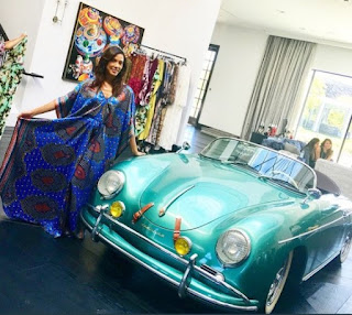 Kristen Baker Bellamy posing for picture with a classic car