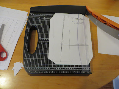 Pattern page sitting on a paper trimmer with trimming blade raised.