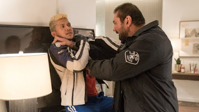 Movie still for the 2019 film "Stuber" where Dave Bautista strangles Iko Uwais in a hotel room