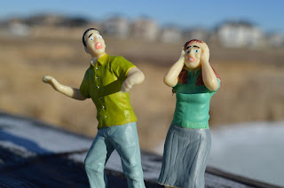 two plastic figurines that look frightened