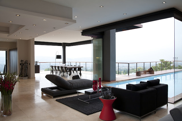 Picture of black sofas in the living room by the swimming pool
