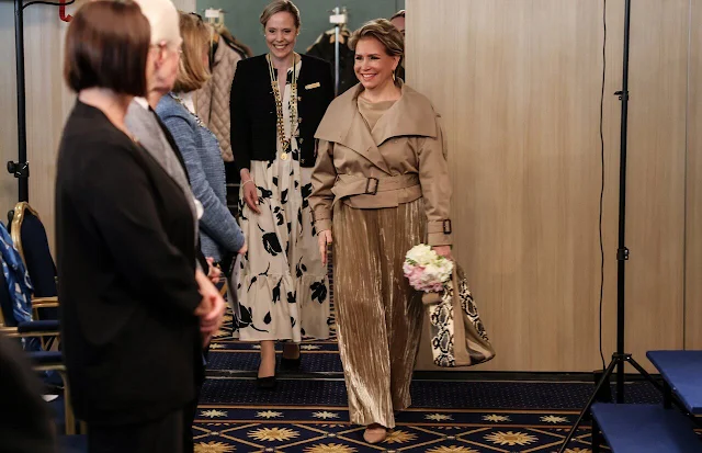 Grand Duchess Maria Teresa wore a cold beige double-breasted trench jacket by Acne Studios. Soroptimist Luxembourg-Doyen club