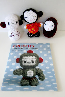 Image of the Crobots crochet pattern book with some handmade examples