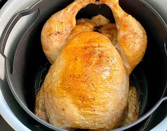 Whole steam roasted chicken in the Ninja Foodi multicooker.