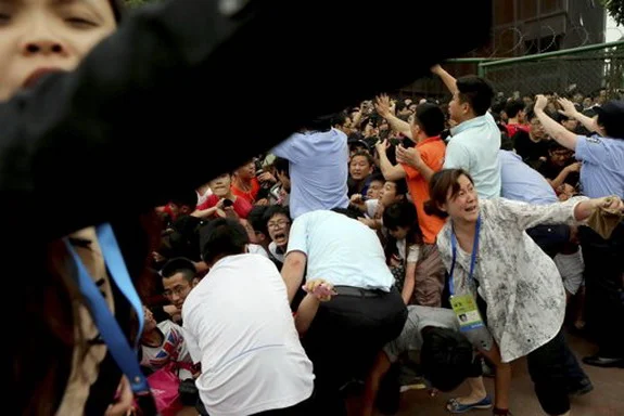 A crowd reacts during a stampede by fans of David Beckham at Tongji University in Shanghai