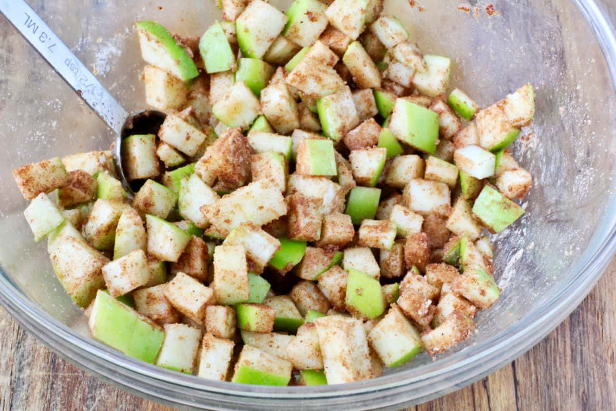 Chopped and sugared apples in a bowl.
