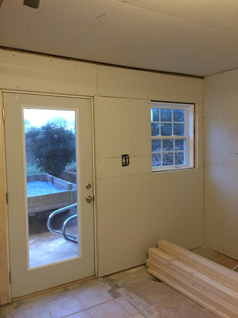 See what a difference drywall and lighting made in our basement!