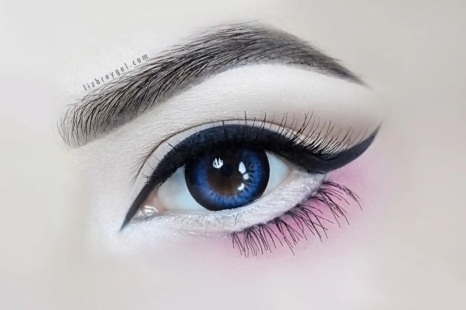 close-up of an eye with eye-enlarging blue circle lenses and anime makeup look with false lashes and eyeliner