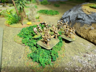 Japanese infantry stalk though the jungle