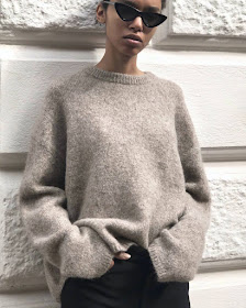 Cool Minimalist Spring Outfit Idea: Black Cat-Eye Sunglasses, Neutral Sweater, and Black Pants