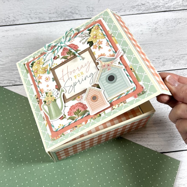 Pretty spring scrapbook album in a box with birdhouses, flowers, and twine