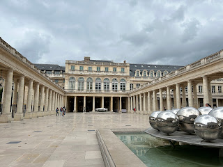 A building and metal bubble-like sculpture in the Jardin du Palais Royale.