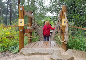 Knowsley Ultimate Brick Safari child crossing over Wobbly Bridge near tigers