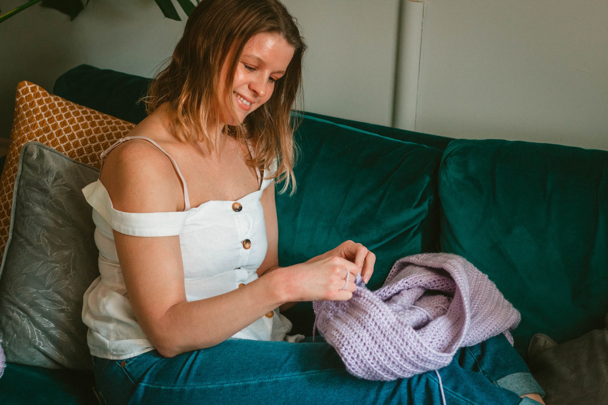 girl crocheting lilac jumper - 5 creative hobbies for self care blog post