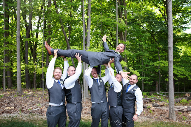 groomsmen lifting groom at Noah's Event Venue in Auburn Hills Michigan