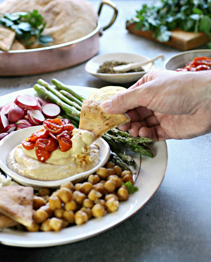 Recipe for roasted tomatoes and a tutorial on putting together a hummus party platter and fixings bar.