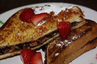 Photo of nutella and banana toasted sandwich with strawberries