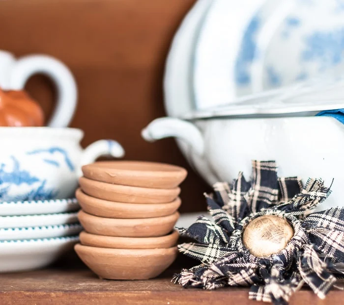 homespun sunflower, stack of terracotta butter pats, blue and white vintage dishes