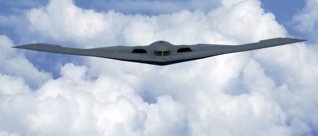 A B-2 Spirit soars through the sky after a refueling mission