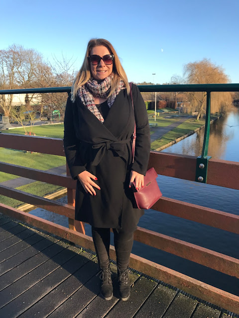 Basking in the winter sunshine wearing a classic black trench coat