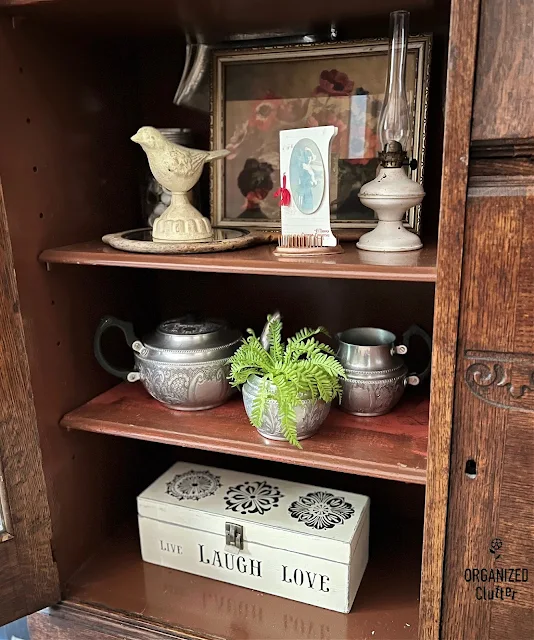 Photo of neutral decor in an antique secretary cabinet.