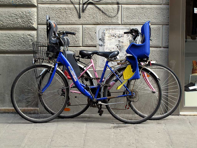 Two bicycles locked in almost perfect symmetry, via Ricasoli, Livorno