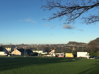 View of Edinburgh city center on a clear blue day.