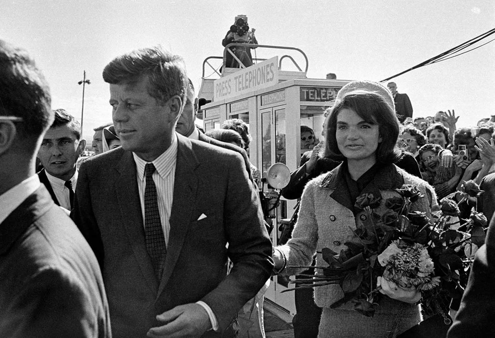 In this November 22, 1963 photo, President Kennedy and his wife, Jacqueline Kennedy, arrive at Love Field airport in Dallas, Texas.