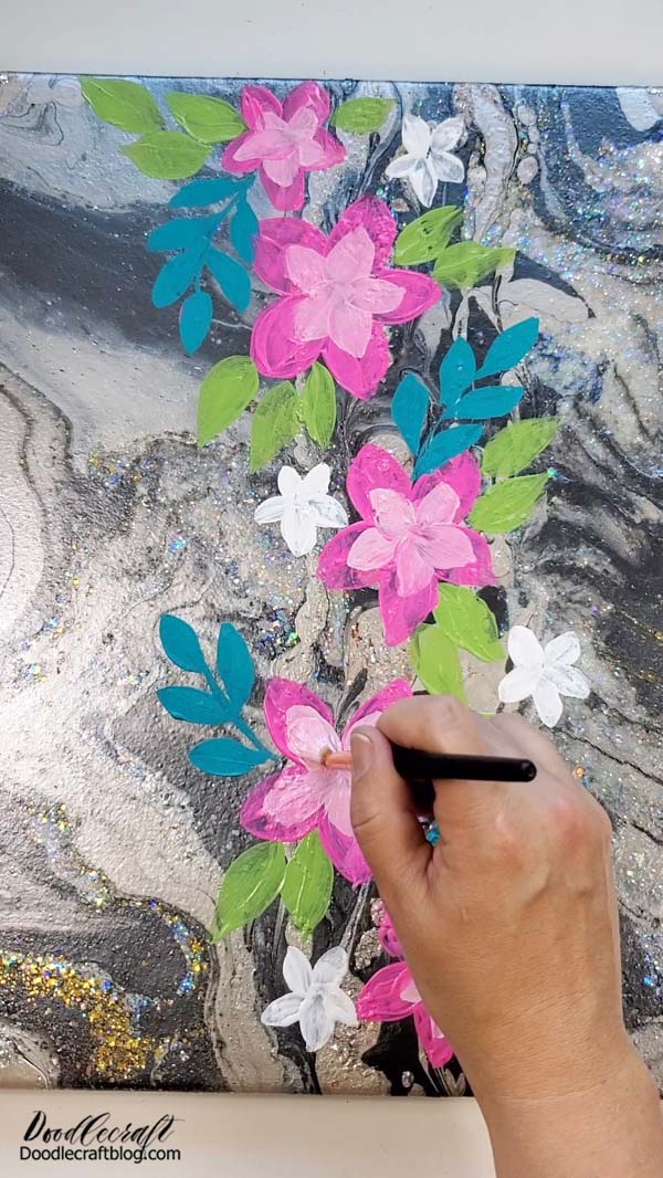 Then paint in some bright green leaves and add some light pink to the center of the pink hibiscus flowers.