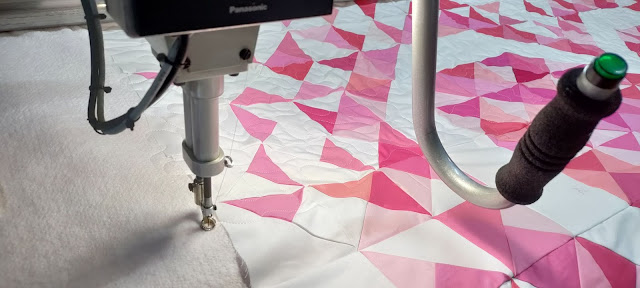 Meander quilting on an Exploding Heart quilt