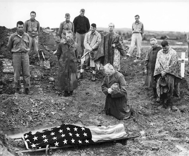 US Marine Colonel Francis Fenton conducting the funeral of his son Private First Class Mike Fenton, near Shuri, Okinawa, May 1945.