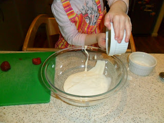 Mixing yoghurt and cream for Eton Mess recipe.