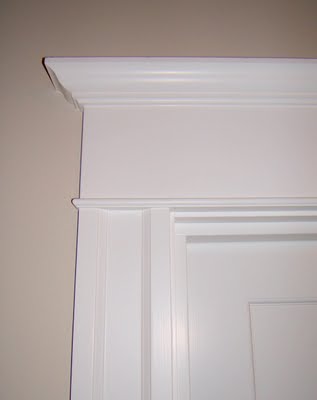 Height added to a traditional door frame by adding simple moldings.