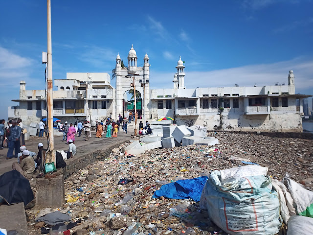 Front of Haji Ali Dargah with rubbish along pathway outside