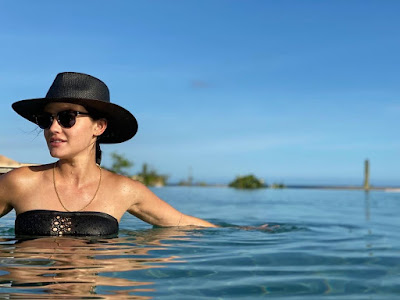 Lucy Hale black swimsuit, hat and sunglasses in the pool