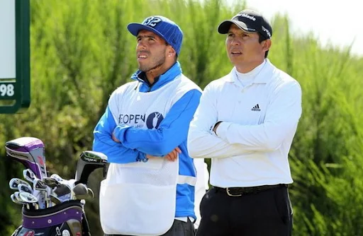 Carlos Tévez looks on with Andrés Romero during the 2012 British Open Golf Championship
