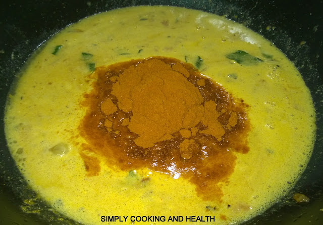 Adding curry powder garam masala and turmeric powder