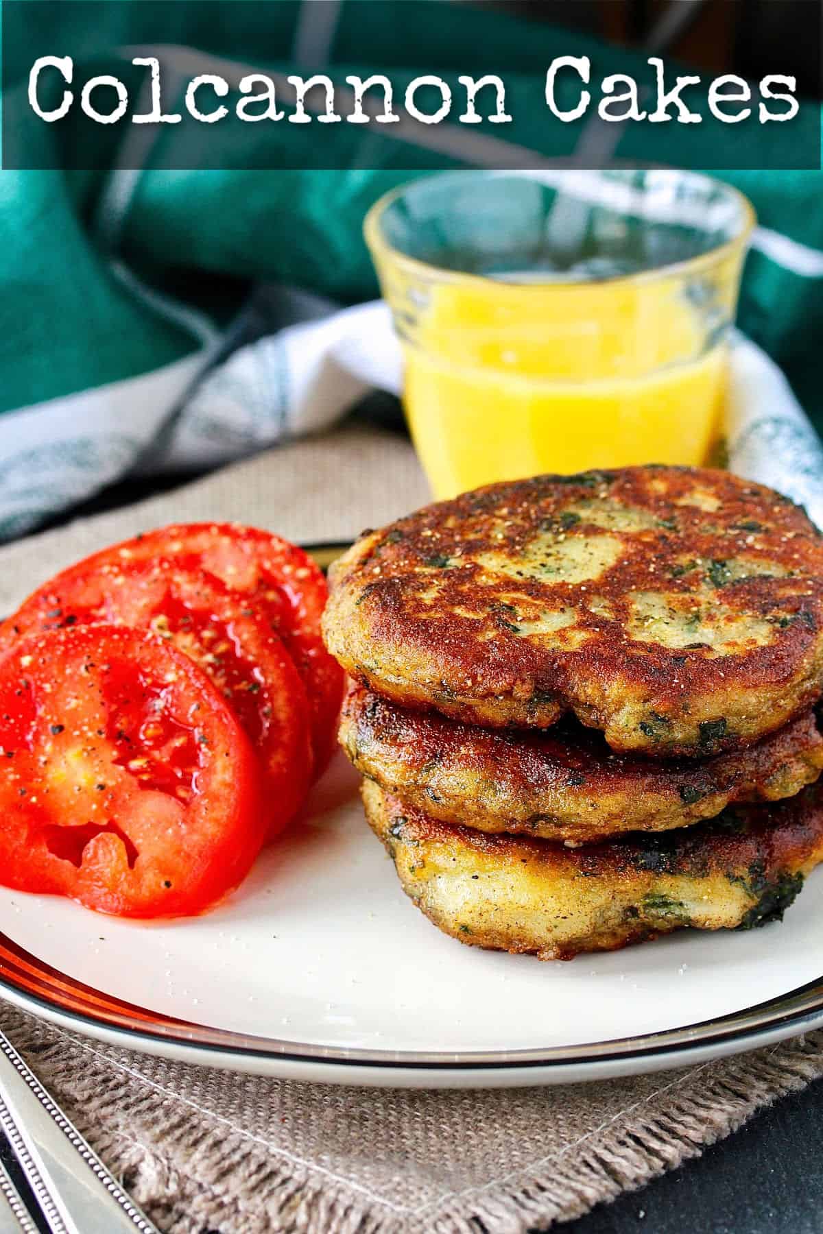 Colcannon Cakes on a plate with tomatoes.
