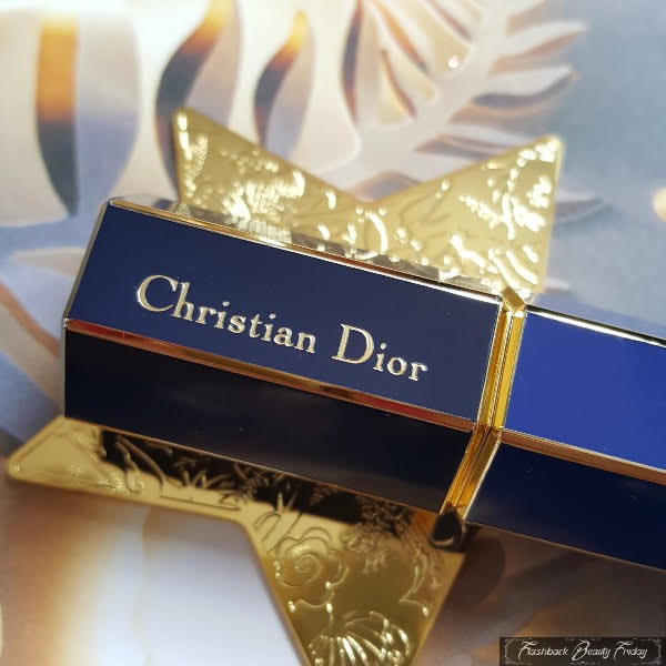 close up of engraved Christian Dior branding on side of vintage navy lipstick case