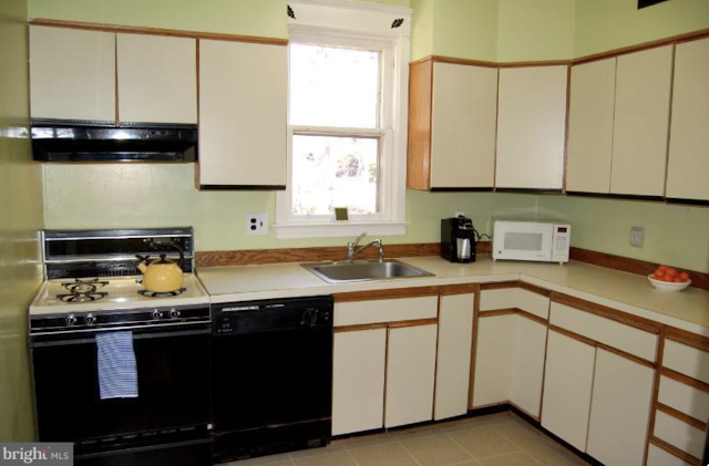 color photo of 1980s kitchen with white laminate-front cabinets, Sears Americus• 114 N Jackson St, Arlington, Virginia • 1923
