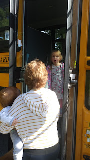 Mommy and Aiden getting Ellie off the bus on her first day or school.