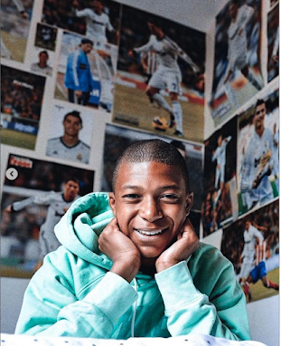 Kylian Mbappe in his room with Real Madrid posters