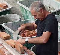 Image of a man bricklaying 