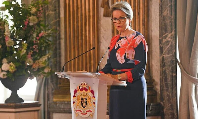 Queen Mathilde wore a navy floral-print silk-faille maxi wrap dress by Etro, and red orange pumps by Natan