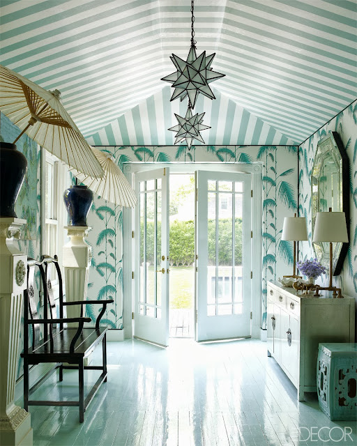 Chinoiserie inspired foyer with Chinese furniture, light blue wallpaper, a striped ceiling, parasols and high gloss floors in Oscar PR Girl's home