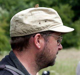 Ringlet butterfly, Aphantopus hyperantus, on a walker's hat.  Bumblebee walk in Jubilee Country Park, led by Jenny Price.  19 June 2011.