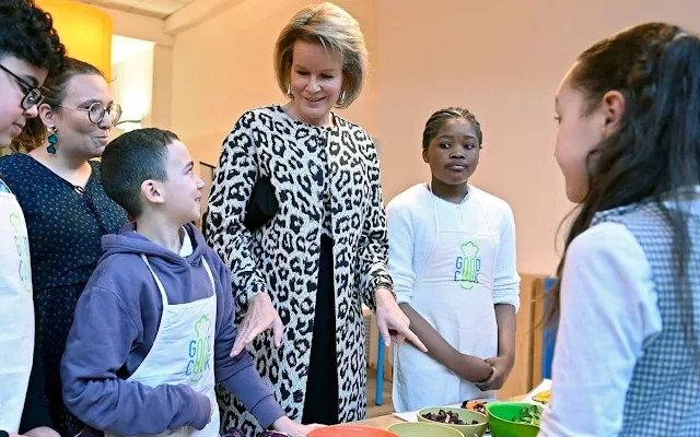 Queen Mathilde wore a white black leopard print coat and top by Armani, Natan, Maje. GoodPlanet Belgium