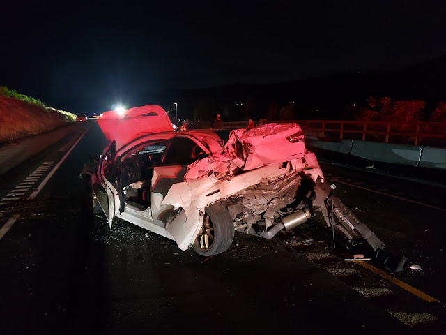 A white passenger car with severe damage in the front and the back after being involved in a crash during the evening of Sept. 22 on SR 28 near Rock Island in Douglas County.