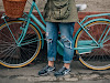 Person in Brown Jacket Standing Beside Bicycle